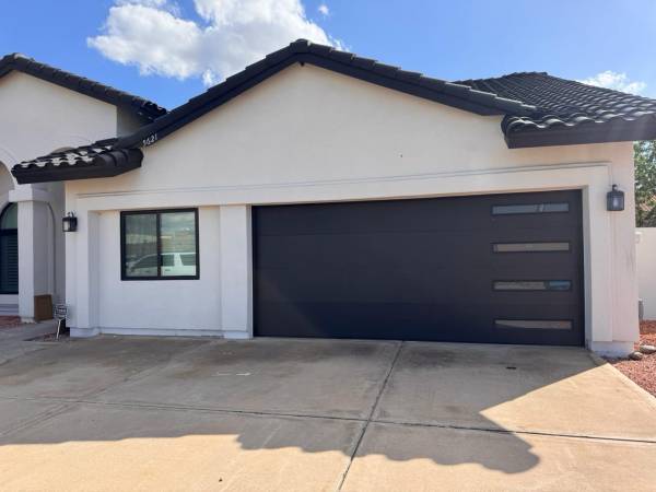 Garage door repair in Bell Gardens, California on a residential garage with the door opened for service